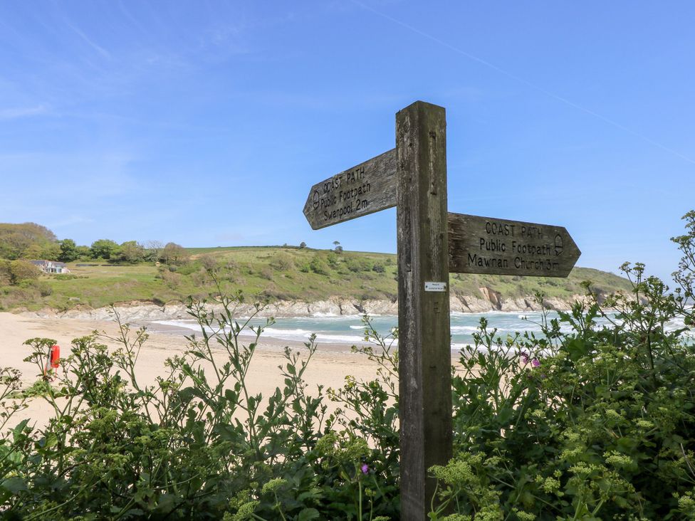 A signpost pointing to public paths near the beach at Riverside Barn Stithians