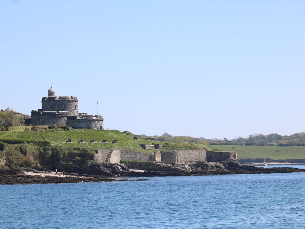 A castle on a hillside by the water at Riverside Barn in Stithians