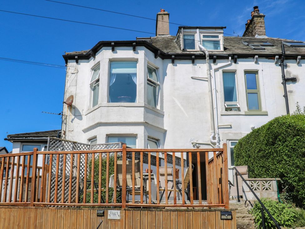 An exterior view of a house with a deck and garden at Ferncliffe