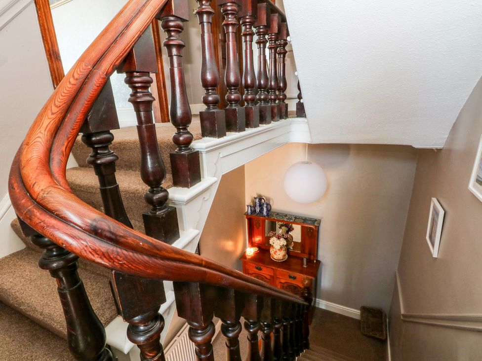 A staircase and cabinet in a hallway at Ferncliffe