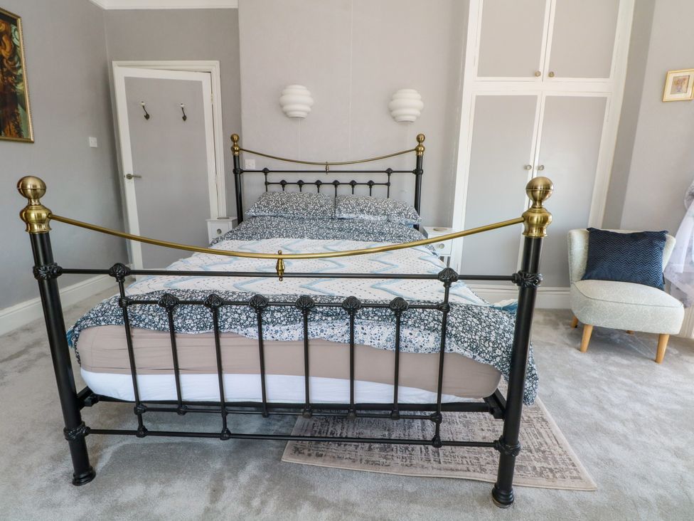 A bedroom with a bed and wardrobe at Ferncliffe