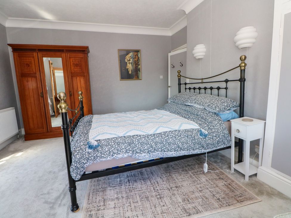 A bedroom with a bed and wardrobe at Ferncliffe