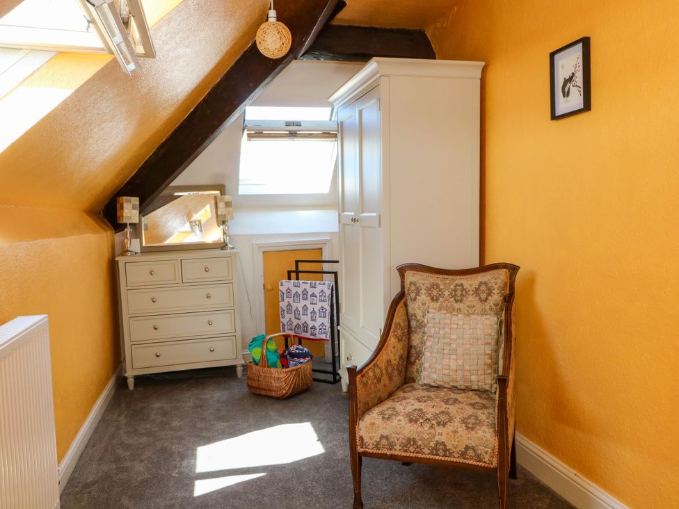 An attic with a chair and dresser at Ferncliffe in 