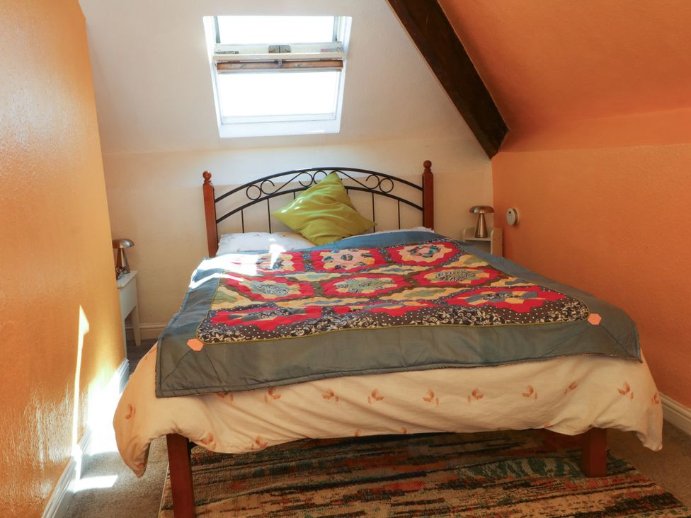 A bedroom with a bed and window at Ferncliffe