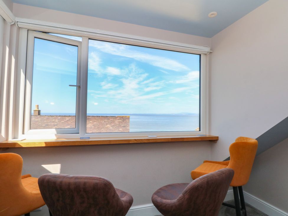 A window with a sea view and chairs at Ferncliffe in 
