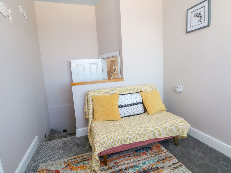A sofa with cushions on a landing at Ferncliffe