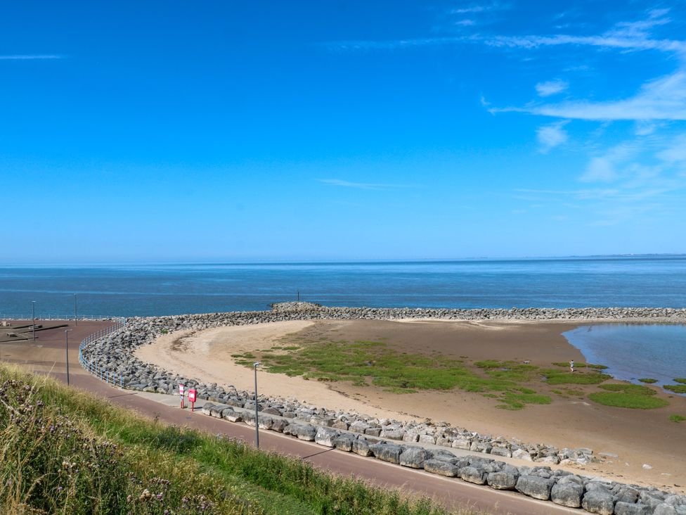 A beach view with rocks and sand along the coastline at Ferncliffe