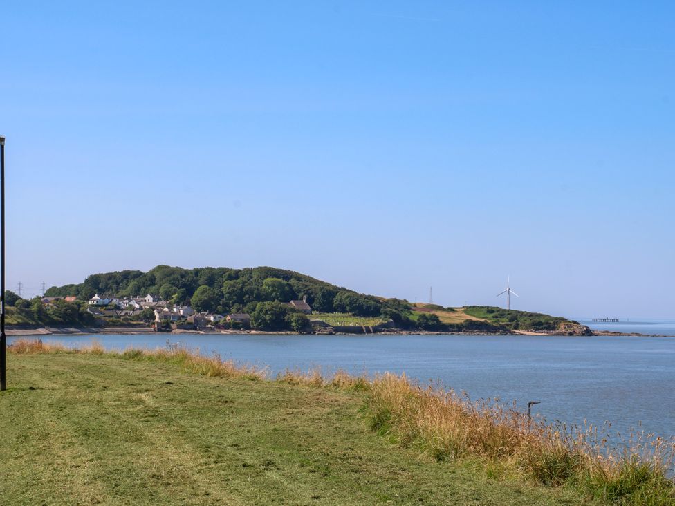 A view of an island with trees and houses near the shoreline at Ferncliffe in 