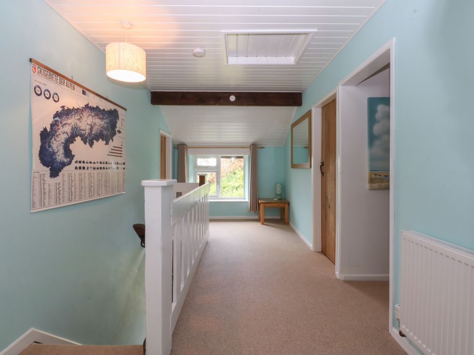 A hallway with a map on the wall and a table at Neuadd Wen Gaerwen