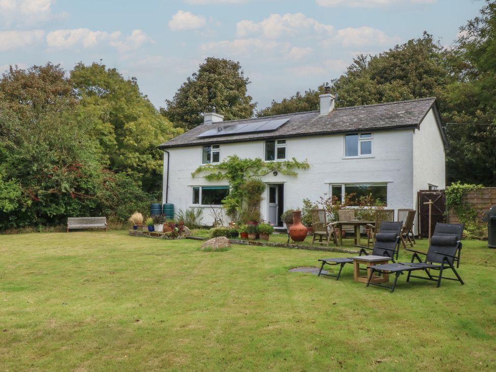 A house with garden furniture and flower pots at Neuadd Wen in Gaerwen