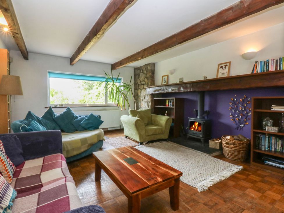 A living room with a sofa and armchair at Neuadd Wen in Gaerwen