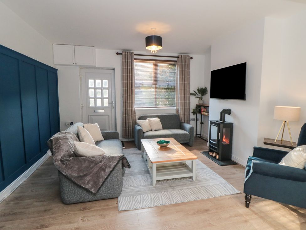 A living room with a coffee table and TV at 23 South Lackenby Eston