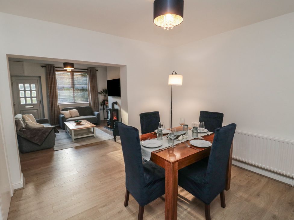A dining room with a table set for dinner at 23 South Lackenby in Eston