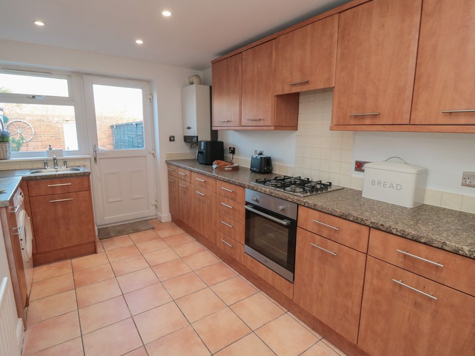 A kitchen with cabinets, appliances, and a door at 23 South Lackenby in Eston