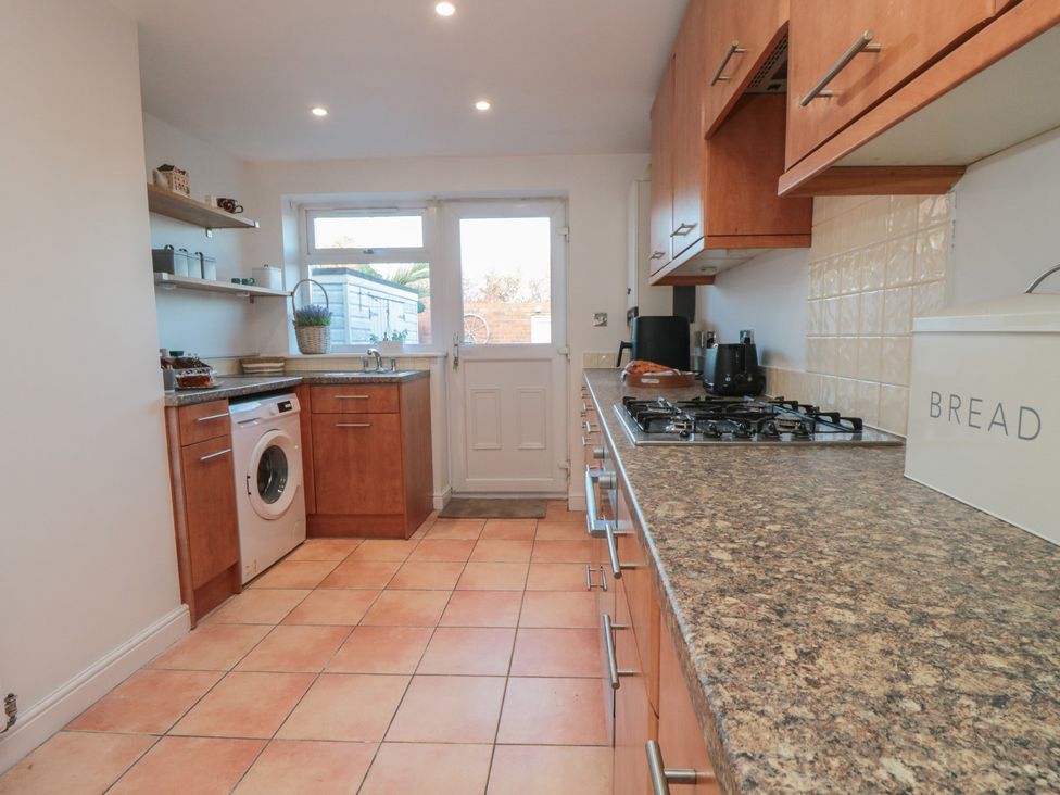 A kitchen with a washing machine and gas stove at 23 South Lackenby in Eston