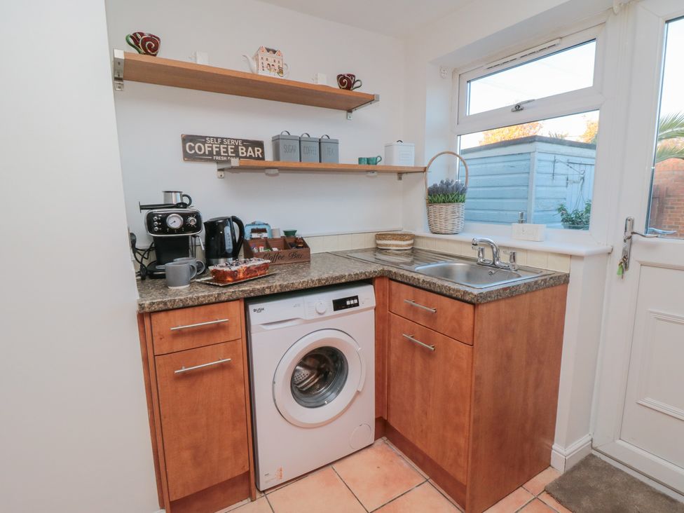 A kitchen with a washing machine and sink at 23 South Lackenby Eston