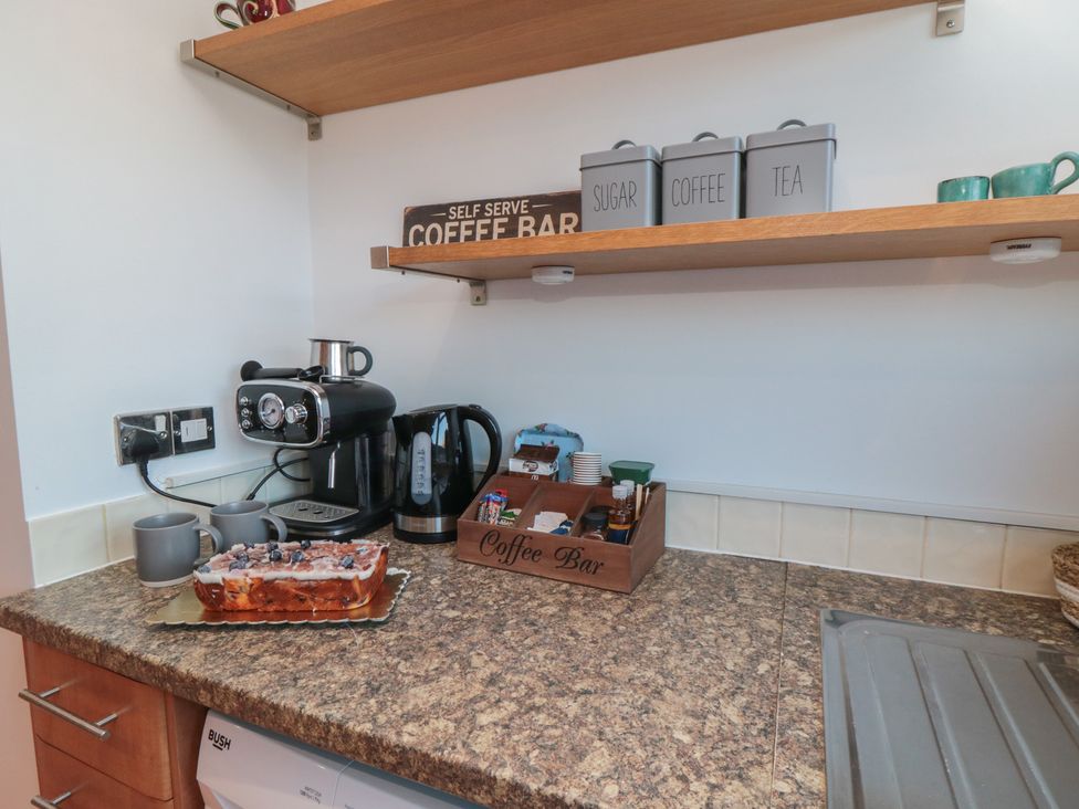A kitchen countertop with coffee maker and cake at 23 South Lackenby Eston