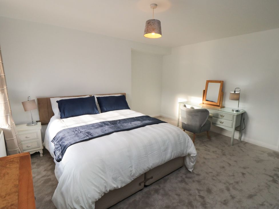 A bedroom with a bed and dressing table at 23 South Lackenby in Eston