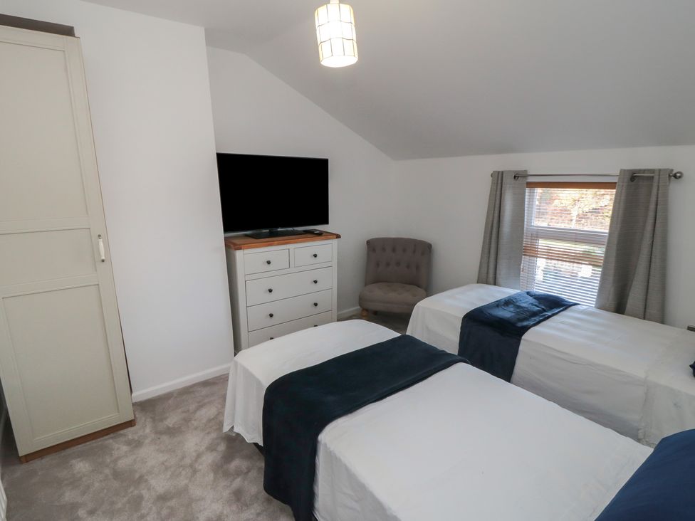 A bedroom with two beds and a television at 23 South Lackenby in Eston