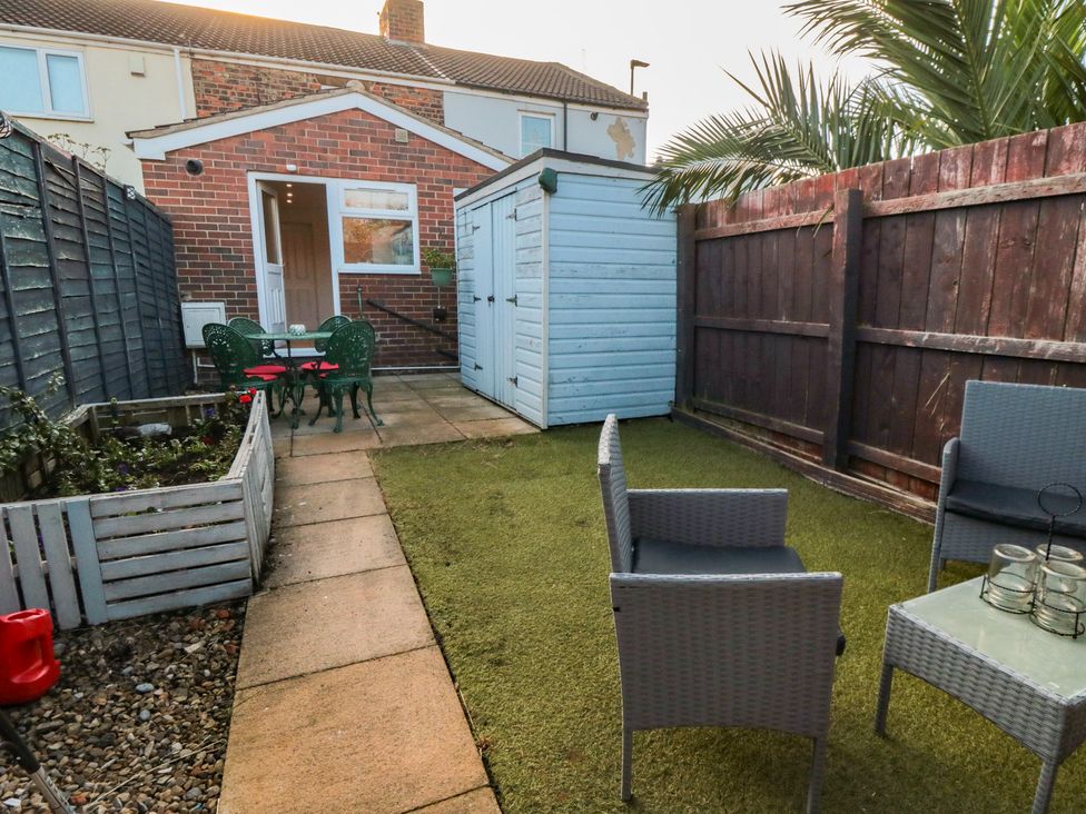 A garden with a table and chairs at 23 South Lackenby in Eston