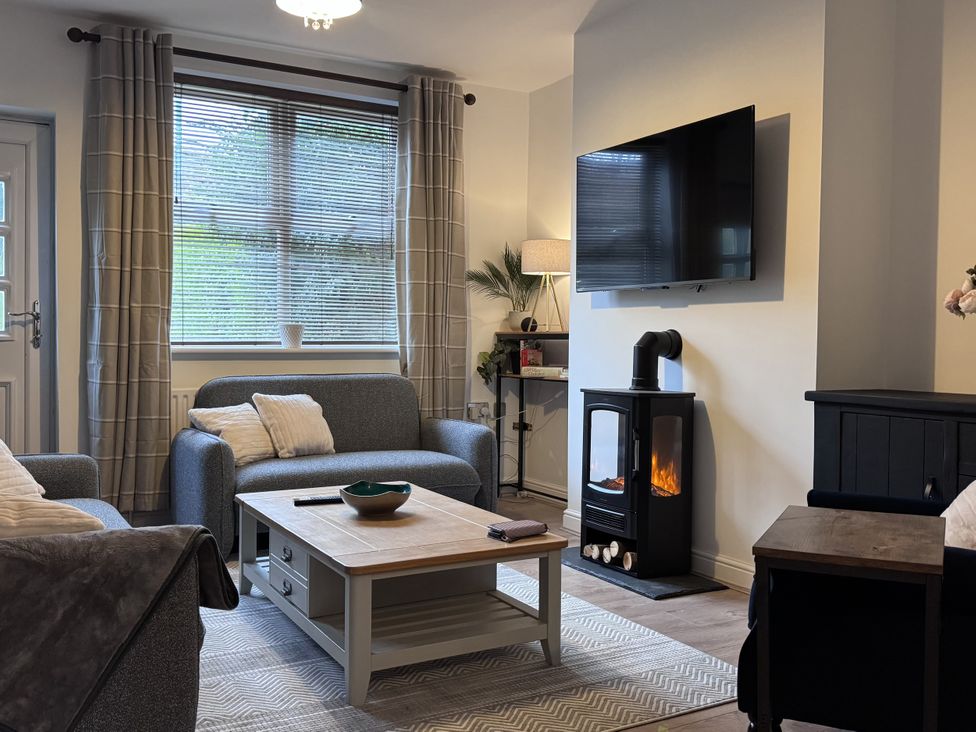 A living room with a sofa and coffee table at Ironstone Cottage in Eston