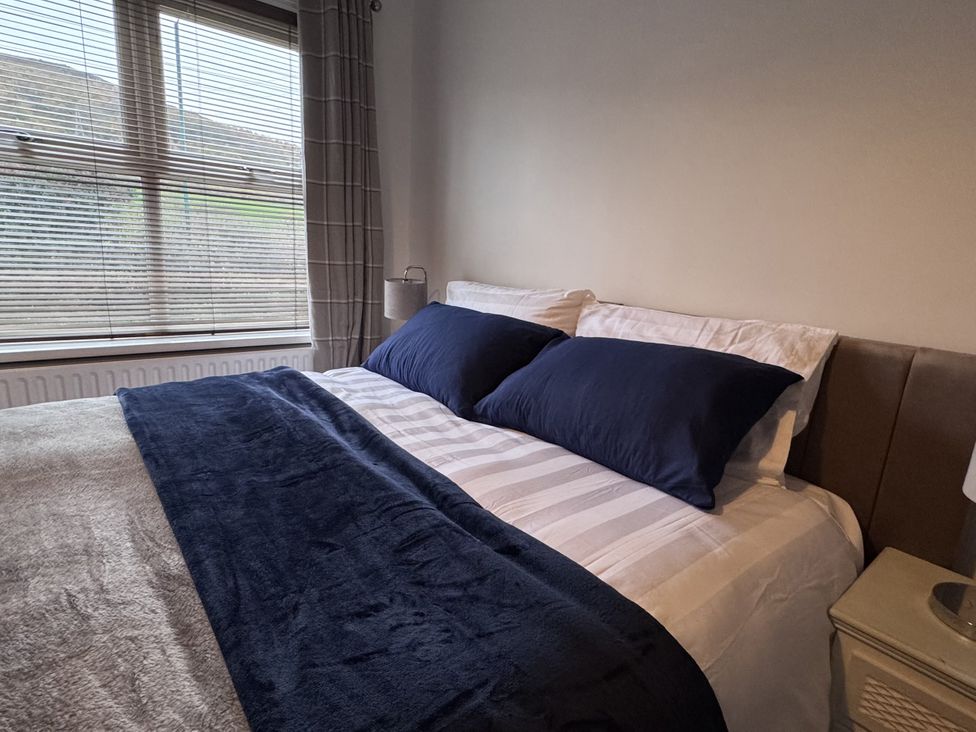 A bedroom with a bed and pillows at Ironstone Cottage in Eston