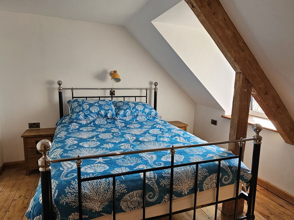 A bedroom with a bed and bedside tables at Awel Deg in Cardigan