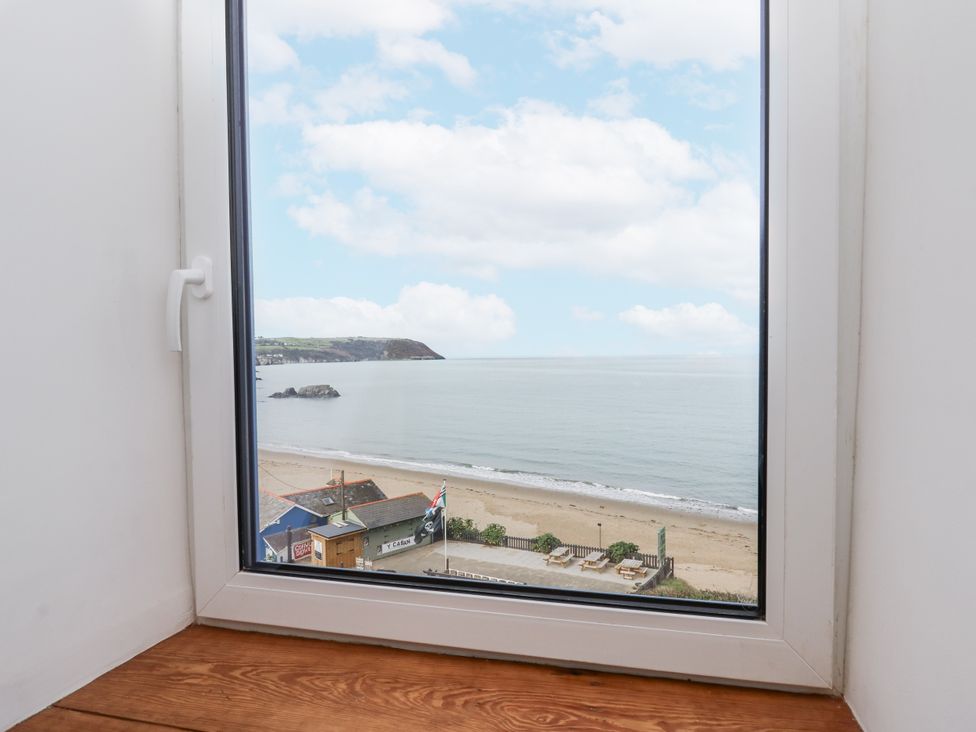 A view of the beach and sea from a window at Awel Deg, Tresaith