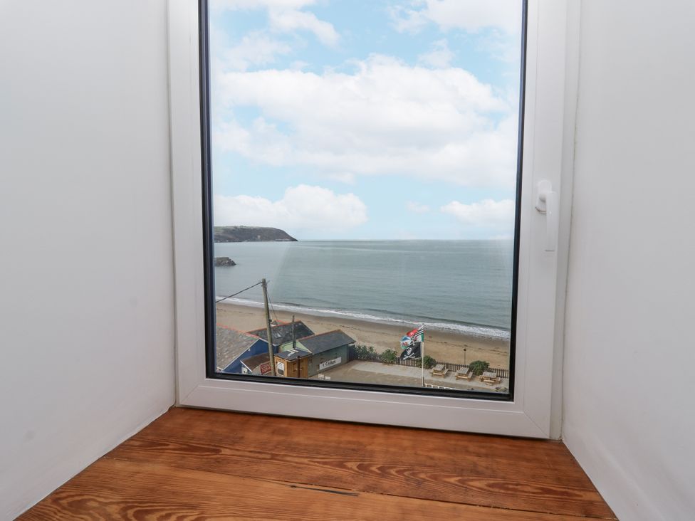A view of the ocean and beach from a window at Awel Deg, Tresaith