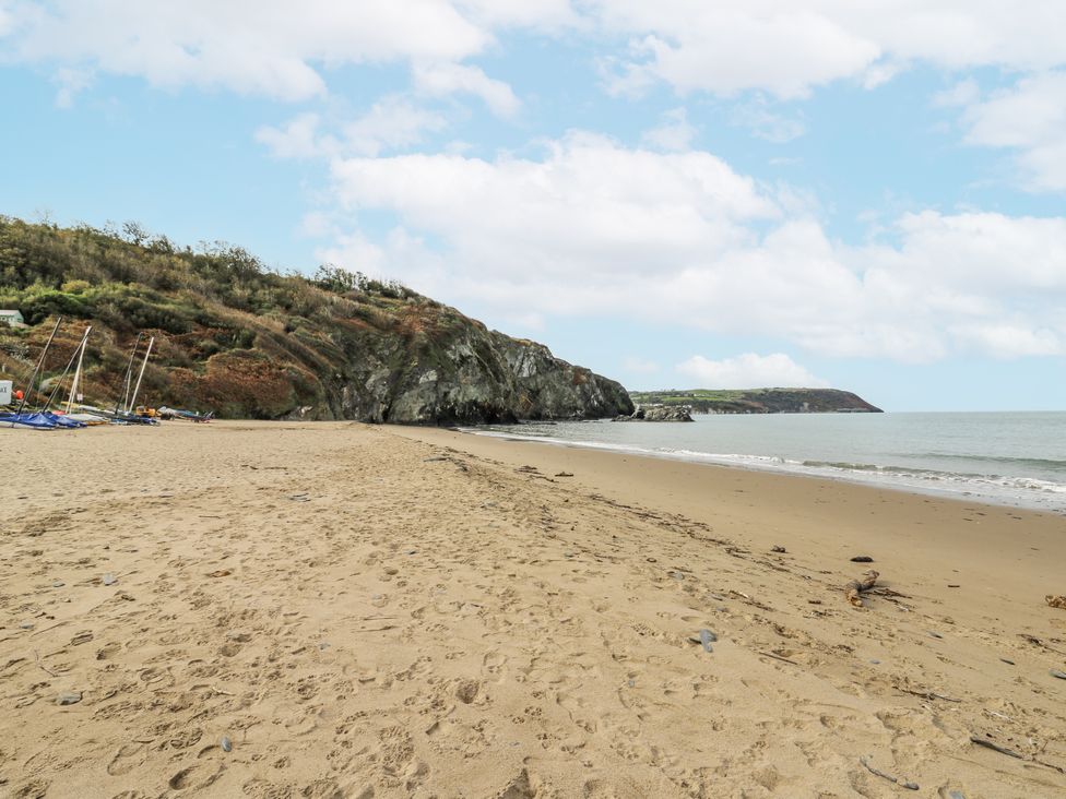 A beach with sand and water at Awel Deg, Tresaith