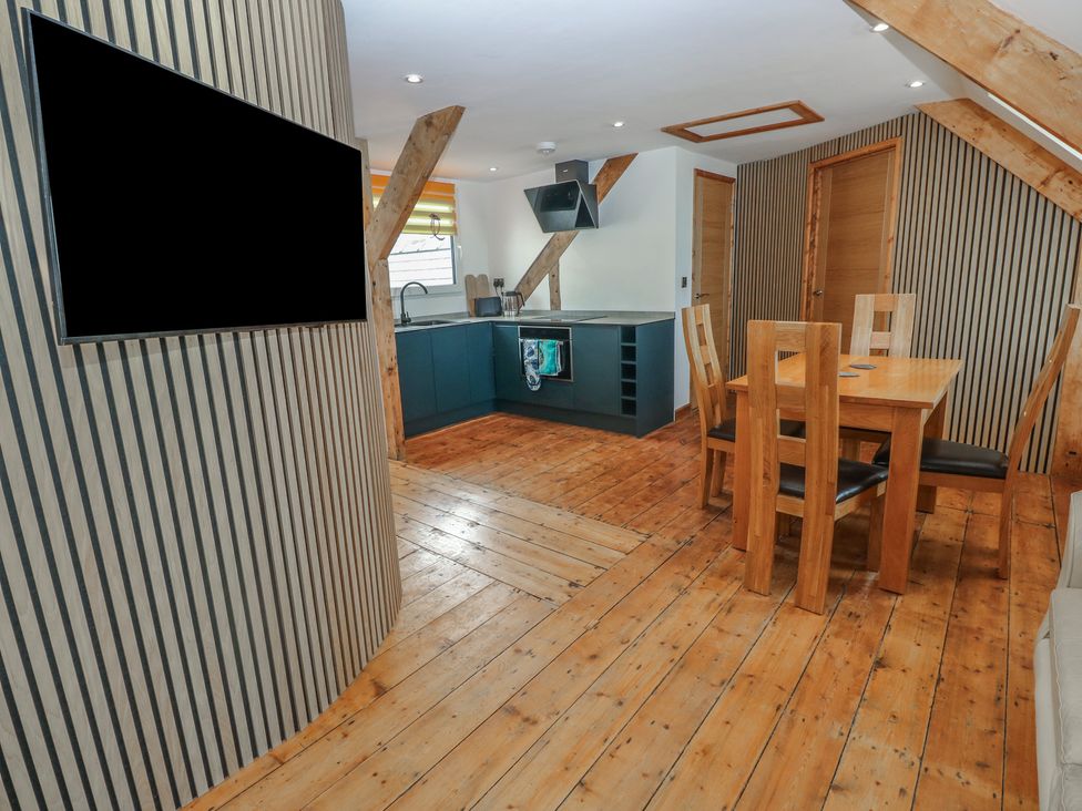 A kitchen with a dining area at Awel Deg, Tresaith