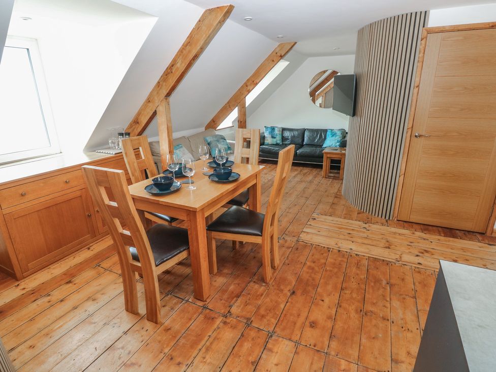 A dining room with a table and chairs at Awel Deg, Tresaith