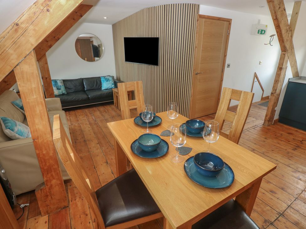A dining room with a table set for four at Awel Deg, Tresaith