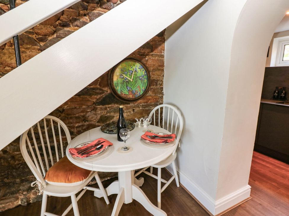 A dining area with a table and chairs at Ashtree Cottage
