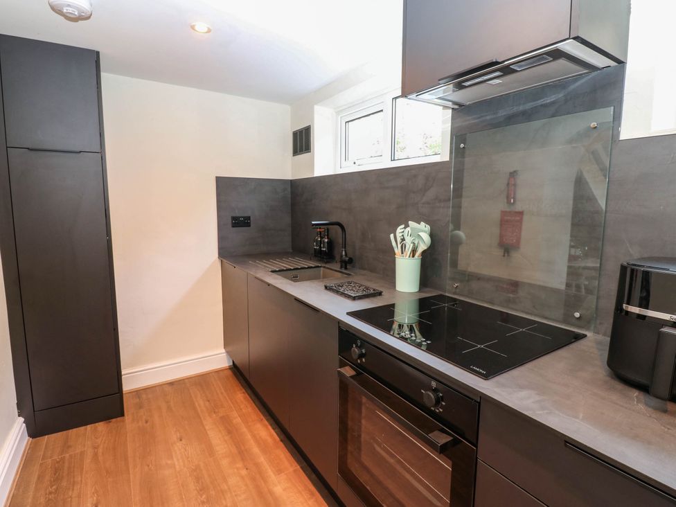 A kitchen with sink and appliances at Ashtree Cottage