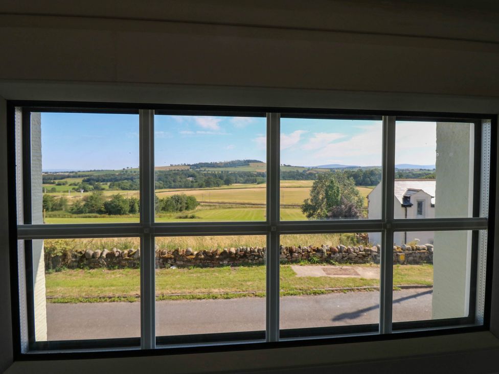 A view of fields and trees from a window at Ashtree Cottage