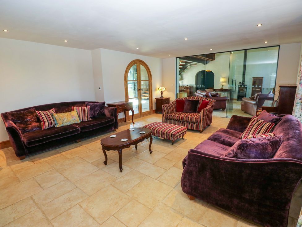 A living room with sofas and a coffee table at Bib Knowl Farm in Littleborough