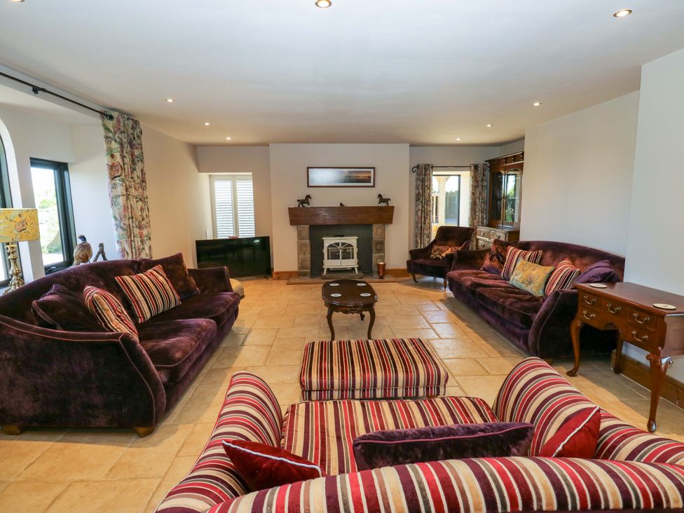 A living room with sofas and a coffee table at Bib Knowl Farm in Littleborough