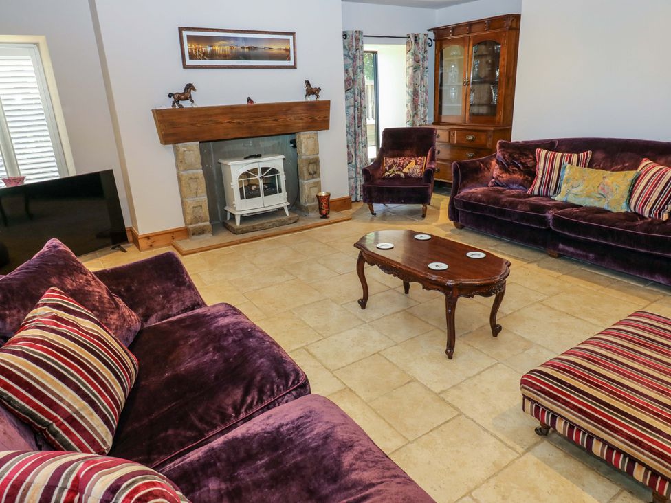 A living room with a sofa and coffee table at Bib Knowl Farm in Littleborough