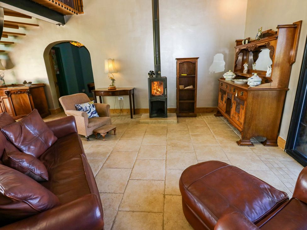 A living room with a stove and furniture at Bib Knowl Farm in Littleborough