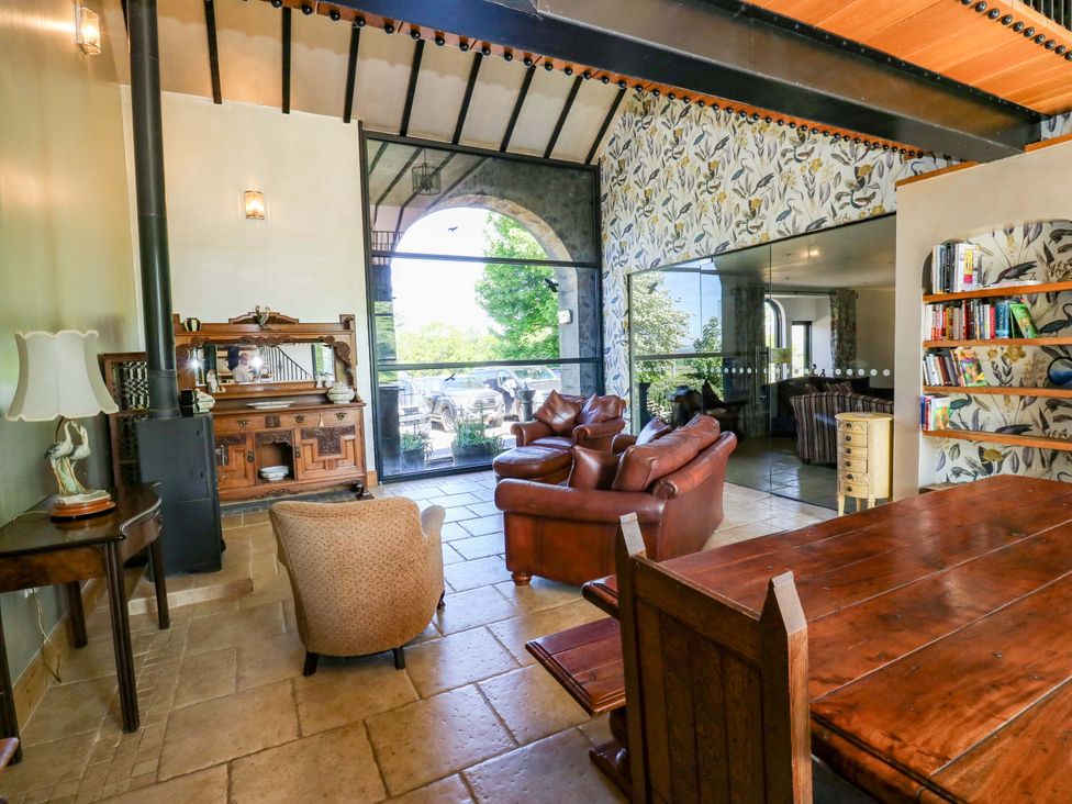 A living room with seating and a table at Bib Knowl Farm in Littleborough