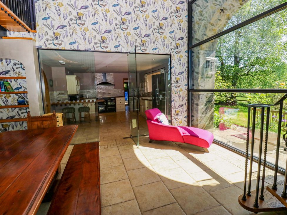 A dining room with a table and chairs at Bib Knowl Farm in Littleborough