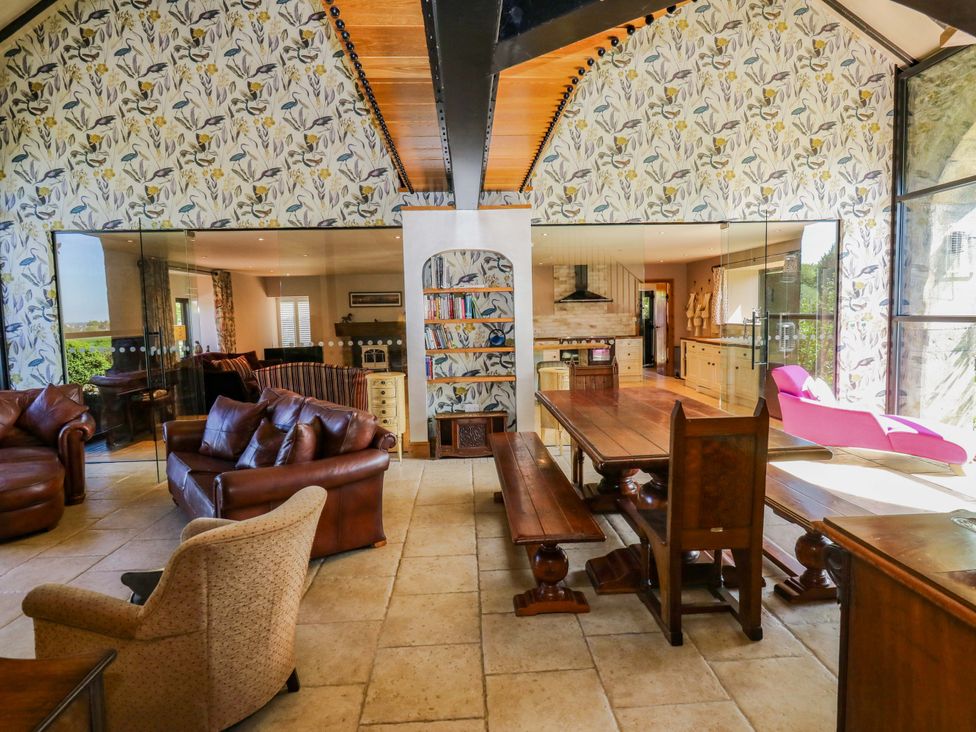 A living room with a dining table and sofa at Bib Knowl Farm in Littleborough