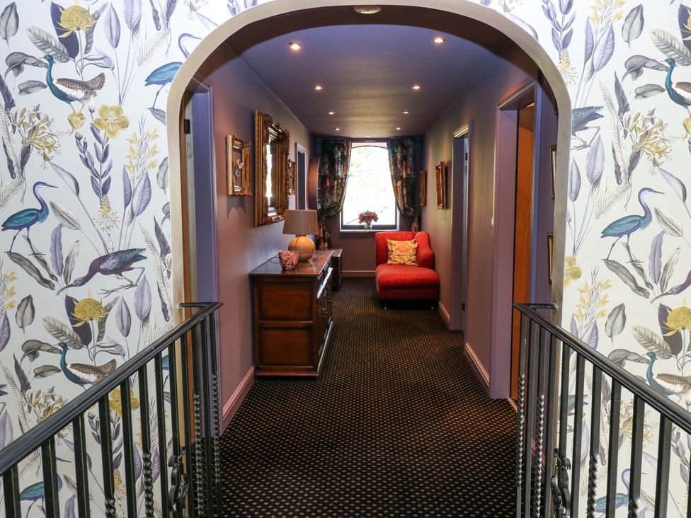 A hallway with a sofa and side table at Bib Knowl Farm in Littleborough