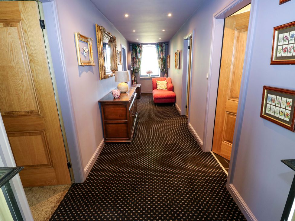 A hallway with a sofa and console table at Bib Knowl Farm in Littleborough