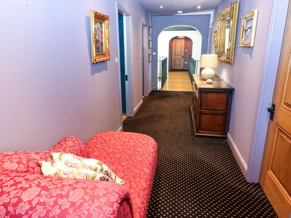 A hallway with a sofa and console table at Bib Knowl Farm in Littleborough