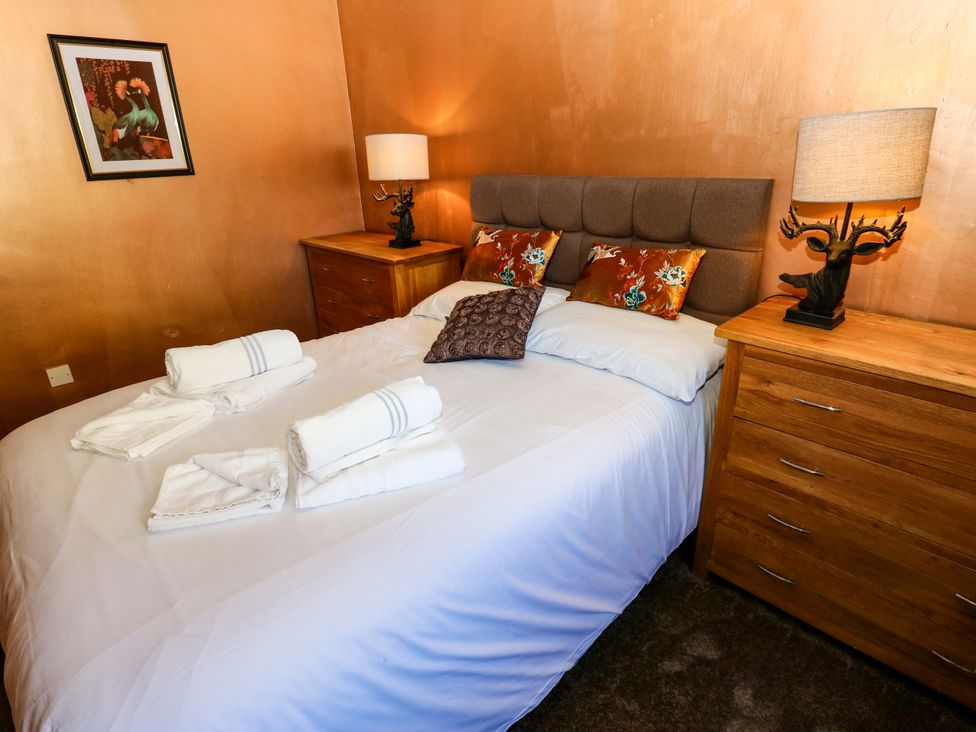 A bedroom with a bed and bedside tables at Bib Knowl Farm in Littleborough