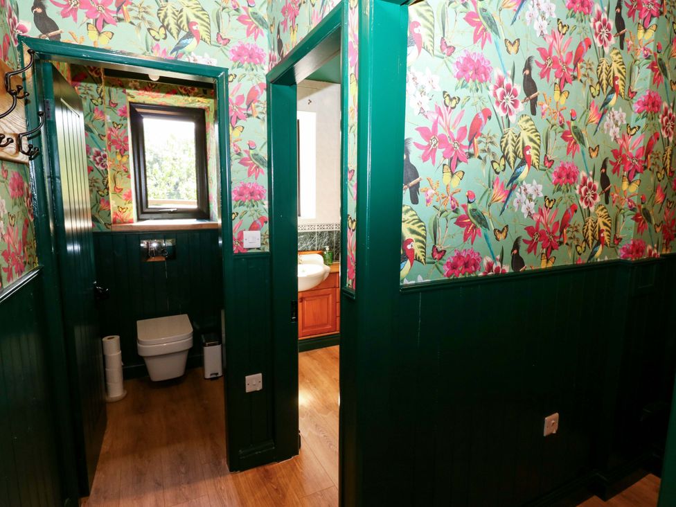 A bathroom with a toilet and sink at Bib Knowl Farm in Littleborough