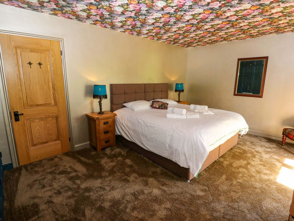 A bedroom with a bed and nightstand at Bib Knowl Farm in Littleborough