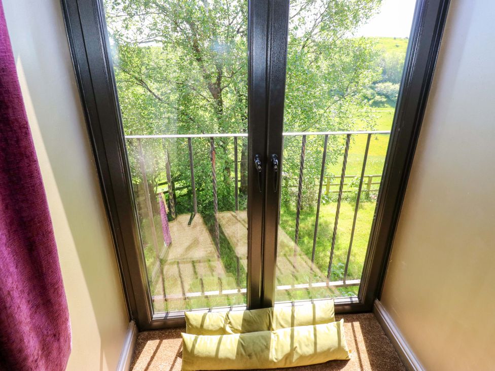 A balcony view with a door opening to green fields at Bib Knowl Farm Littleborough